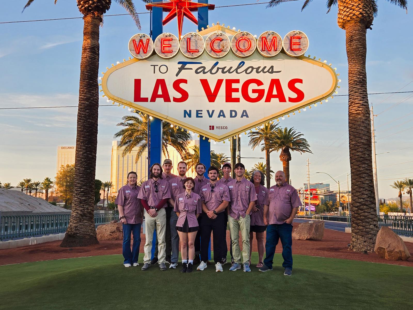 Students and faculty gather for photo under the "Welcome to Fabulous Las Vegas Nevada" sign